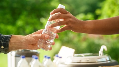 Hand holding water bottle