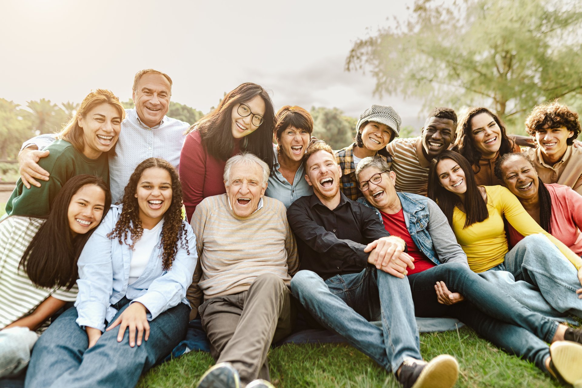 Happy multigenerational people having fun in public park