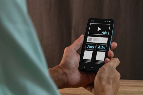 Person scrolling past digital ads ignoring advertisements