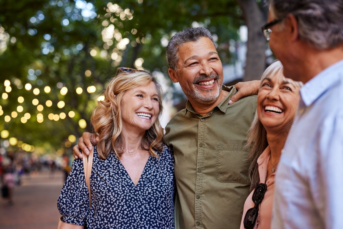 Group of happy people sharing a moment outdoors in a lively city street