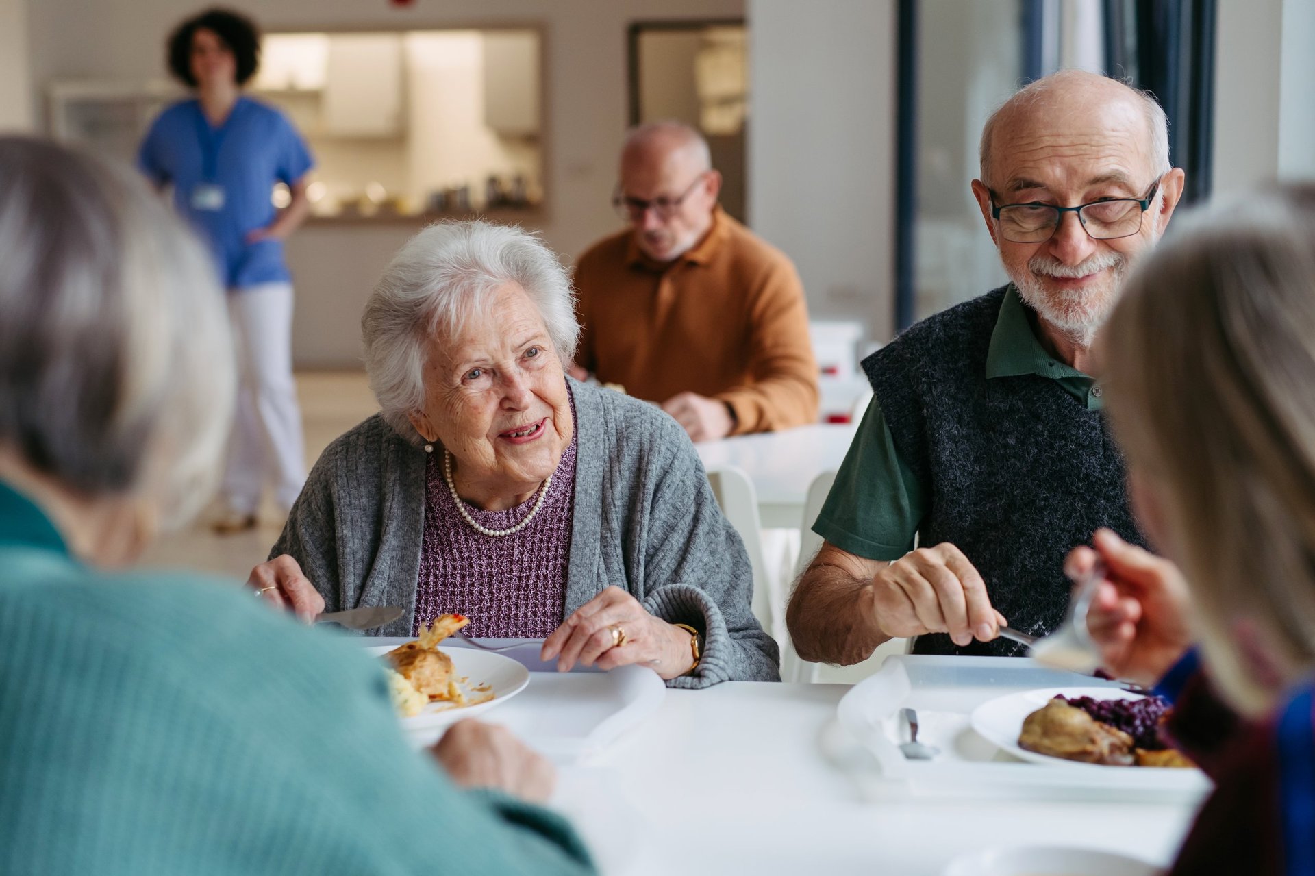 Elderly people having lunch in community center